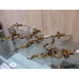 THREE SIMILAR ORMOLU TWO LIGHT WALL BRACKETS, EACH WITH ROCOCO FOLIAGE ARMS AND BACK PLATES AND WITH