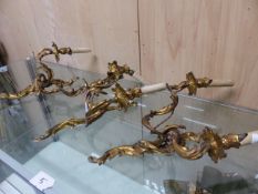 THREE SIMILAR ORMOLU TWO LIGHT WALL BRACKETS, EACH WITH ROCOCO FOLIAGE ARMS AND BACK PLATES AND WITH