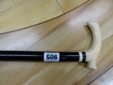 AN IVORY HANDLED EBONY WALKING STICK. H 86cms.