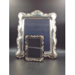 A SILVER HALLMARKED PHOTO FRAME, VELVET BACKED 26cms X 21cms, TOGETHER WITH A SILVER PLATED