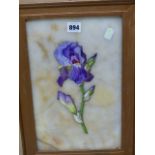 A GILT FRAMED MARBLE PANEL INSET WITH AN IRIS PAINTED IN ENAMELS. H 41 x 29cms.