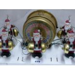 SANTA'S GRAND MARCHING BAND OF FIVE SANTA CLAUS FIGURES EACH BEATING TWO BRASS BELLS.