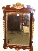 A GEORGIAN STYLE PARCEL GILT MAHOGANY FRAMED RECTANGULAR MIRROR, THE CUT WORK TOP CENTRED BY THE