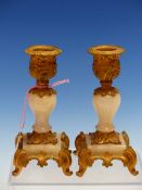 A PAIR OF ORMOLU AND WHITE AGATE BALUSTER CANDLESTICKS, THE NOZZLES AND FOUR FEET CAST WITH ROCOCO