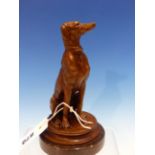 AFTER BARYE, A BRONZE FIGURE OF A GREYHOUND SEATED ON A CARPET ROUNDEL. H 17.5cms.