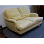 A BESPOKE QUALITY HOWARD STYLE DEEP SEATED TWO SEAT SETTEE WITH FEATHER CUSHIONS IN YELLOW DAMASK