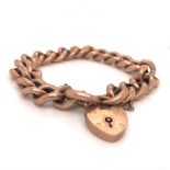 A 9ct OLD ROSE GOLD CURB LINK CHARM BRACELET EACH LINKED STAMPED 9ct, COMPLETE WITH PADLOCK AND