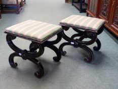 A PAIR OF THOMAS HOPE TASTE EBONISED AND GILT STOOLS, THE UPHOLSTERED SEATS ON CURVED X-SHAPED