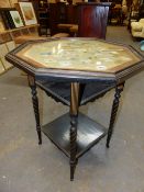 AN EBONISED AND PARCEL GILT TWO TIER GAMES TABLE, THE TOP GLAZED OVER A CHESS BOARD WITH PAINTED