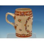 A CHINESE EXPORT MANDARIN PALETTE MUG PAINTED WITH A RESERVE OF FLOWERS OPPOSITE THE REEDED DOUBLE