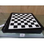 AN ASPREY'S BLACK AND WHITE BOX CHESS BOARD WITH BOX AND EBONY STAUNTON PATTERN CHESS AND