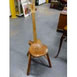 A GUITAR CHAIR, THE BLOND WOOD BACK SAWN WITH FRETS ABOVE A YEW WOOD SADDLE SEAT AND TURNED OAK