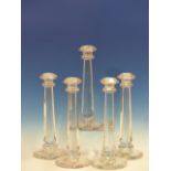 SEVEN HEXAGONAL COLUMNED CLEAR GLASS CANDLESTICKS. H 31cms. TOGETHER WITH A SET OF SIX HI-BALL