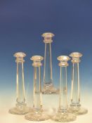 SEVEN HEXAGONAL COLUMNED CLEAR GLASS CANDLESTICKS. H 31cms. TOGETHER WITH A SET OF SIX HI-BALL