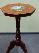 A SWISS FRUITWOOD OCTAGONAL TRIPOD TABLE, THE CARVED TOP WITH A BAND OF OVALS PAINTED WITH LADIES