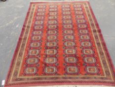 AN ORIENTAL RUG OF BOKHARA DESIGN 235 x 170cms.