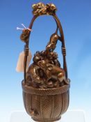 A JAPANESE BRONZE GROUP OF RATS IN AND ABOUT A BASKET OF FRUIT. H 23cms