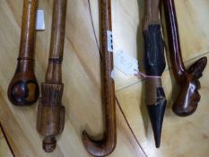 AN 1849 MEASURING STICK, ANOTHER WALKING CANE WITH PARQUETRY POMMEL HANDLE TOGETHER WITH THREE CANES