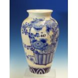 A JAPANESE BLUE AND WHITE OVOID VASE PAINTED WITH A BASKET OF CHRYSANTHEMUMS OPPOSITE A BIRD IN