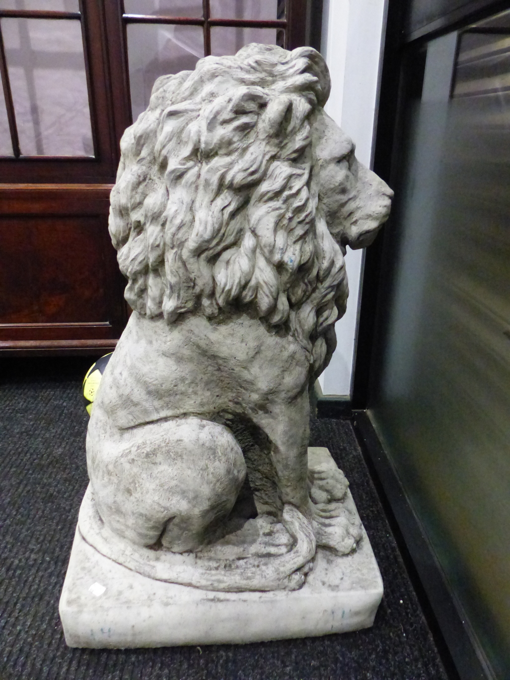A PAIR OF COMPOSITION STONE LIONS SEATED ON RECTANGULAR BASES. H 89cms.
