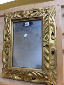 A RECTANGULAR MIRROR IN A BAROQUE STYLE GILT WOOD FRAME PIERCED AND CARVED WITH FOLIAGE. H 53 x 44.