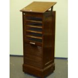 AN OAK FILING CHEST, THE SLATTED DOOR ROLLING DOWN TO REVEAL SLIDE OUT DOCUMENT SHELVES. W 49.5 x