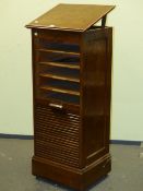 AN OAK FILING CHEST, THE SLATTED DOOR ROLLING DOWN TO REVEAL SLIDE OUT DOCUMENT SHELVES. W 49.5 x