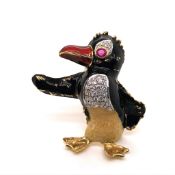 A RUBY, DIAMOND AND ENAMEL NOVELTY PENGUIN BROOCH, KUTCHINKSKY, CIRCA 1969, SET WITH A FACETED