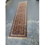 AN ORIENTAL RUNNER OF CAUCASION DESIGN 320 x 80cms.