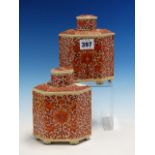 A PAIR OF CHINESE TEA CADDIES AND COVERS, THE HEXAGONAL SECTIONED BODIES PAINTED IN IRON RED WITH