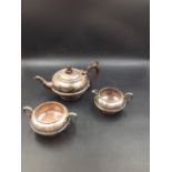 AN EDWARDIAN SILVER HALLMARKED THREE PART TEA SET COMPRISING OF TEA POT, SUGAR BOWL AND CREAMER.