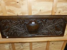 AN OAK PANEL CARVED WITH CENTRAL SHIELD FLANKED BY BIRDS AT THE EDGES OF OAK BRANCHES WITH ACORNS. W