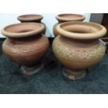 A PAIR OF HATHERN STATION CO. LTD. RED TERRACOTTA PLANTERS A CIRCULAR BAND OF FLOWER HEADS ON THE