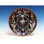 A 19th C. MAIOLICA PLATE PAINTED IN THE CANTAGALLI STYLE WITH GROTESCHI ON A DEEP BLUE GROUND.