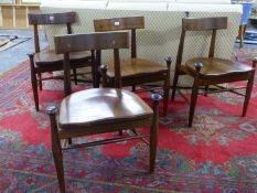 AN INTERESTING SET OF FOUR MID CENTURY WALNUT DINING CHAIRS WITH SADDLE SEATS. (4)