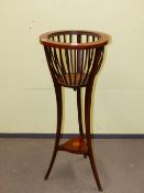 AN EDWARDIAN MAHOGANY PLANTER STAND, THE LINE INLAID CIRCULAR RIM ABOVE SLATTED SIDES, THE