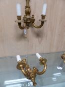 A PAIR OF GILT WOOD TWO BRANCH WALL LIGHTS, THE FLUTED NOZZLES AND ARMS SCROLLING TO THE BASES OF