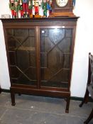 A CHIPPENDALE STYLE BOOKCASE CABINET.