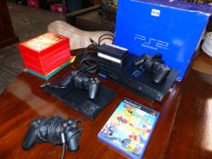 A PLAYSTATION 2 AND GAMES.