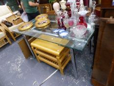 A DESIGNER GLASS TOPPED EXTENDING TABLE.