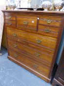 AN EDWARDIAN WALNUT CHEST OF DRAWERS.