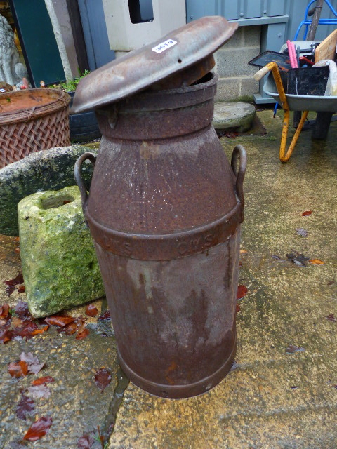 A VINTAGE MILK CHURN.