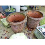 A PAIR OF TERRACOTTA PLANTERS WITH BASKET WEAVE DECORATION.