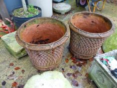 A PAIR OF TERRACOTTA PLANTERS WITH BASKET WEAVE DECORATION.