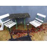 A GARDEN TABLE WITH PAINTED CAST IRON BASE TOGETHER WITH A SIMILAR PAIR OF CHAIRS.