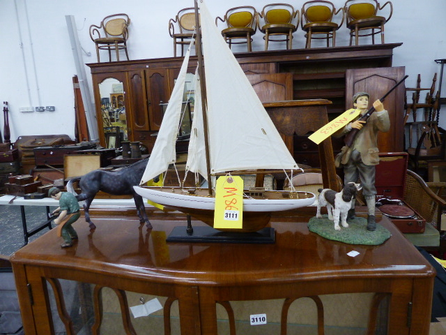 A MODEL BOAT AND TWO FIGURINES, FARRIER AND A SPORTSMAN.