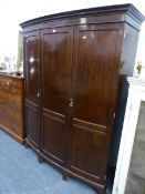 AN EDWARDIAN BOW FRONT WARDROBE.