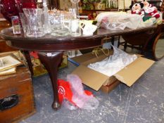 A LARGE MAHOGANY EXTENDING DINING TABLE.