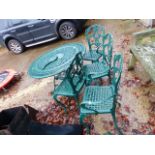 A PAINTED PATIO TABLE WITH FOUR MATCHING CHAIRS.