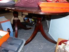 A MAHOGANY DINING TABLE.